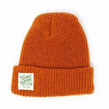 A dark orange beanie with a white square patch with a green text: "FRIENDS OF NATURE.".