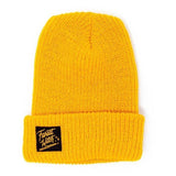 A yellow beanie with a black square patch with a yellow text: "FOREST WITCH."