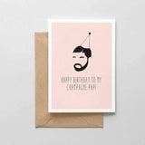 A peach colored card with a black text: "HAPPY BIRTHDAY TO MY CHAMPAGNE PAPI" and an illustration of the singer, Drake, wearing a birthday cone. Comes with a brown envelope.