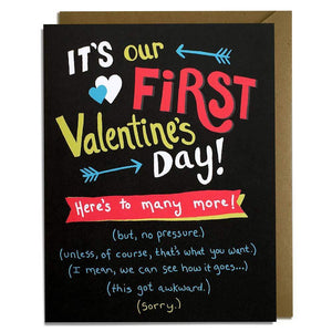 A black card with a colorful text: "IT'S OUT FIRST VALENTINE'S DAYY!"