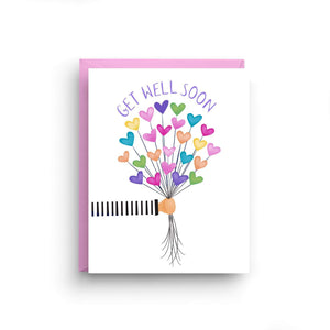 A white card with a text: "GET WELL SOON" and an illustration of a hand holding colorful heart shaped balloons. Comes with a pink envelope.