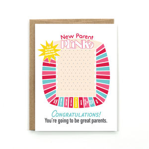 A white card with a text: "NEW PARENT PINKO. CONGRATULATIONS! YOU'RE GOING TO BE GREAT PARENTS" and an illustration of pinko board. 