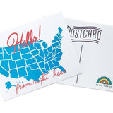 A white postcard with red text: "HELLO FROM RIGHT HERE" and an illustration of map of the US map. Comes with "X" stickers to mark state the card is coming from.