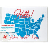A white postcard with red text: "HELLO FROM RIGHT HERE" and an illustration of map of the US map. Comes with "X" stickers to mark state the card is coming from.