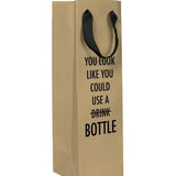 A brown wine gift bag with a black text: "YOU LOOK LIKE YOU COULD USE A DRINK (CROSSED OUT) BOTTLE."